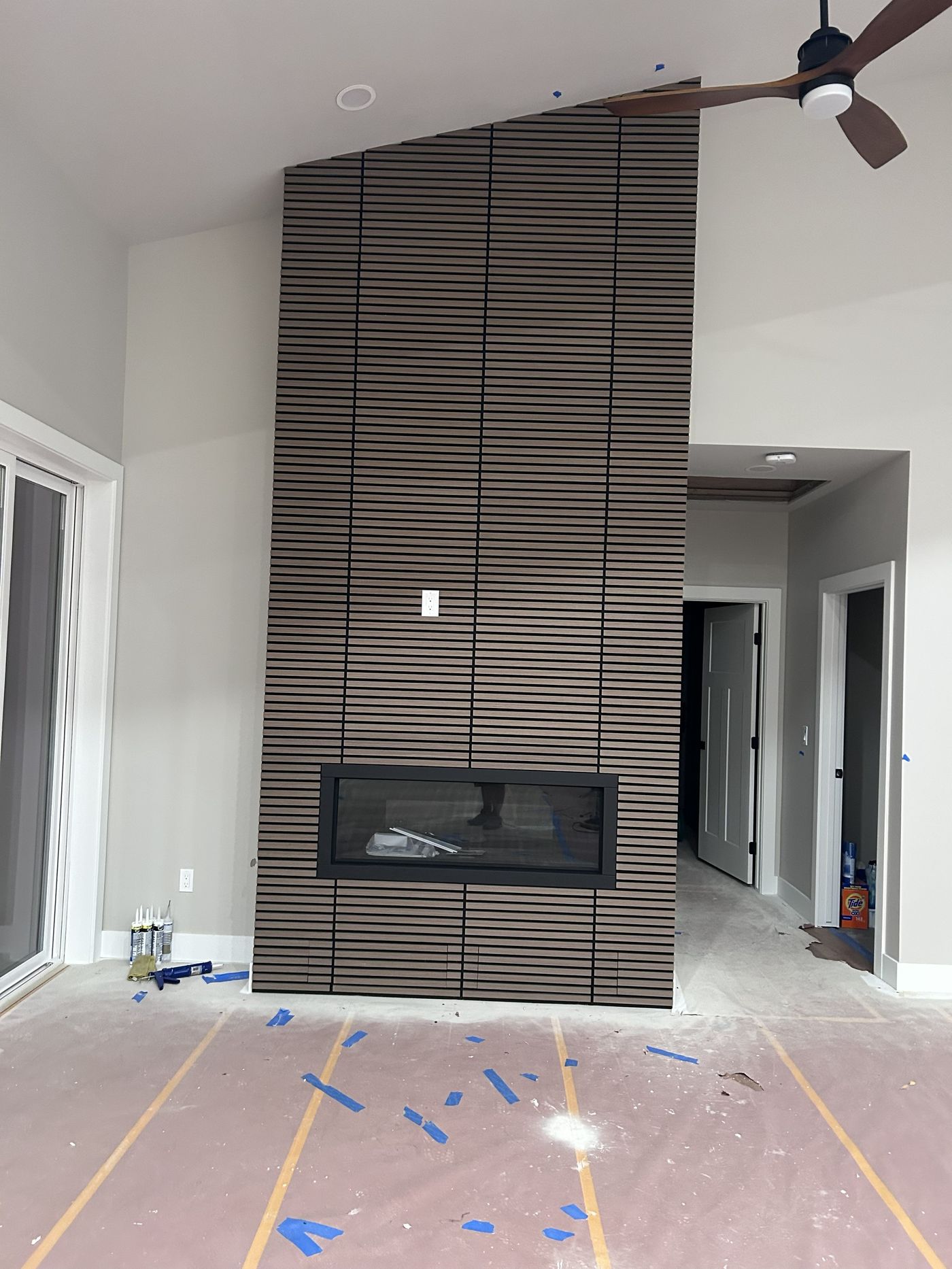 Example slat-wood fireplace accent wall, illustrating typical interior finish style